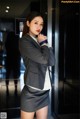 A woman in a business suit posing for a picture.