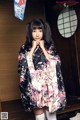 A woman in a kimono posing for a picture.