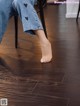 A person sitting on a chair with their feet on the floor.