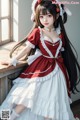 a woman in a red and white dress sitting on a window sill