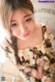 A woman in a floral dress posing for a picture.