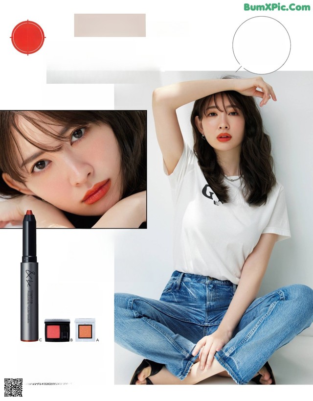 A woman sitting on the ground with her hands on her head.